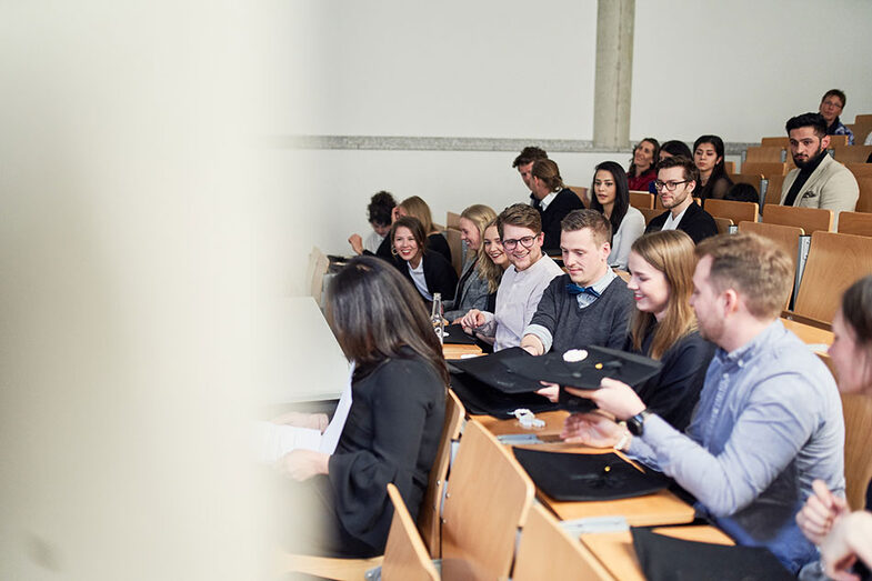 People sitting in a lecture hall at the exhibition/graduation ceremony at the Faculty of Architecture