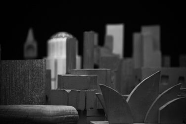 Black and white close-up from a frog's-eye view of the building sculptures cast from fine-grain concrete. The sculpture in the foreground is reminiscent of the famous Sydney Opera House.