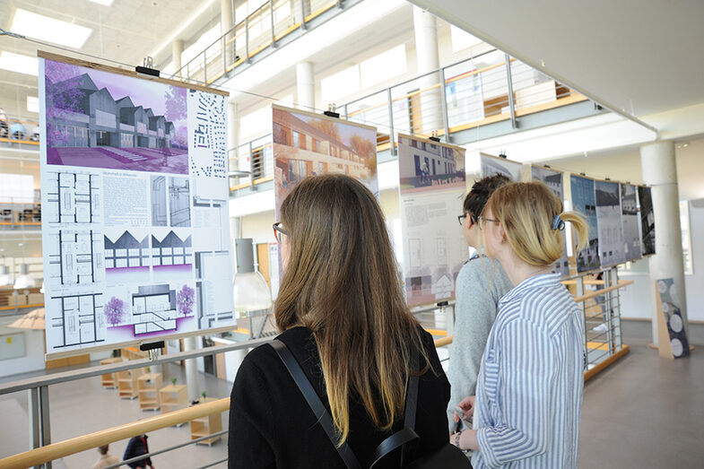 Visitors to the Open Day at the Faculty of Architecture look at posters with building designs