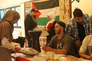 At the Moroccan culture stand, students decorate the table and prepare the food they have brought with them.