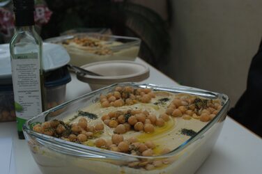 Cultural stand Syria: Close-up of a large bowl of hummus on a decorated table