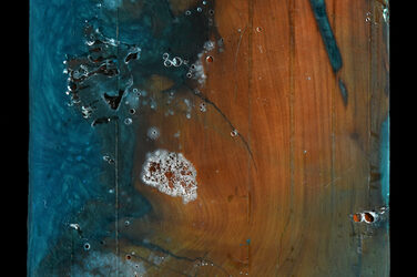 Square wooden panel in which the unevenness was filled with a blue-colored resin and then sanded