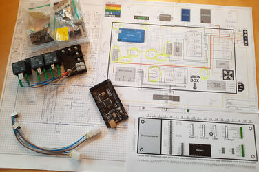 Cables and technical elements are laid out on a circuit diagram.