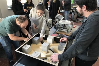 Students prepare a square formwork for their façade panel in the concrete laboratory.