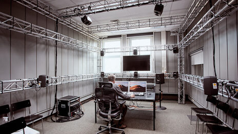 Spatial recording of the 3D space of the sound studio area. A man is working on a computer __ Spatial recording of the 3D space of the sound studio area. A man is working on a computer