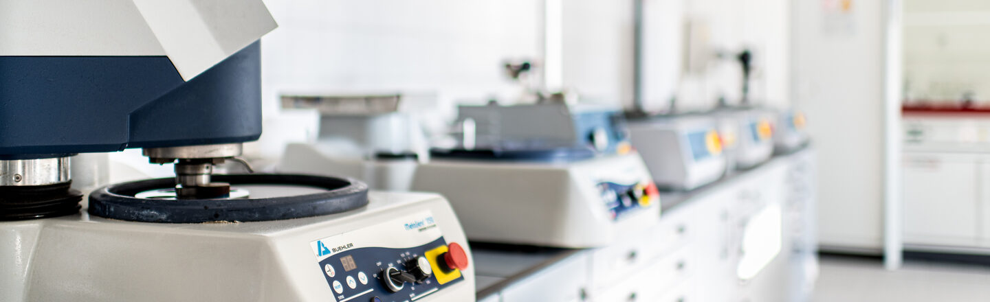 Photo of a row of metallography equipment in the laboratory.