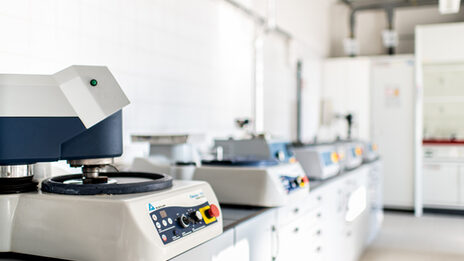 Photo of a row of metallography equipment in the laboratory.
