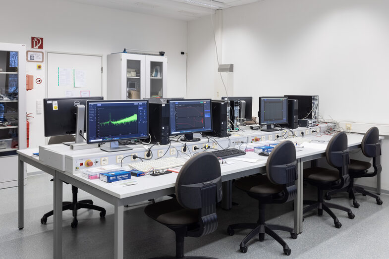 Photo of a laboratory with computers and electronic setups.