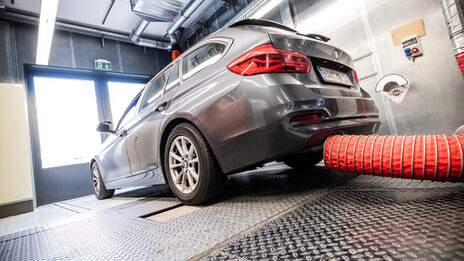 Photo of a vehicle with exhaust extraction on the chassis dynamometer.
