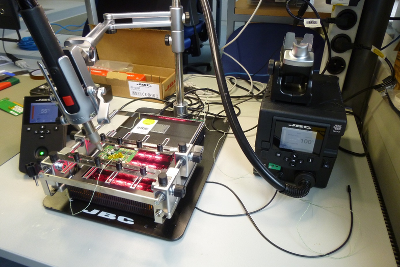 Photo of an SMD repair station and a self-made microcontroller board.