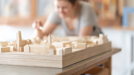 Close-up of an urban planning model with a student in the model making workshop<br>in the Faculty of Architecture