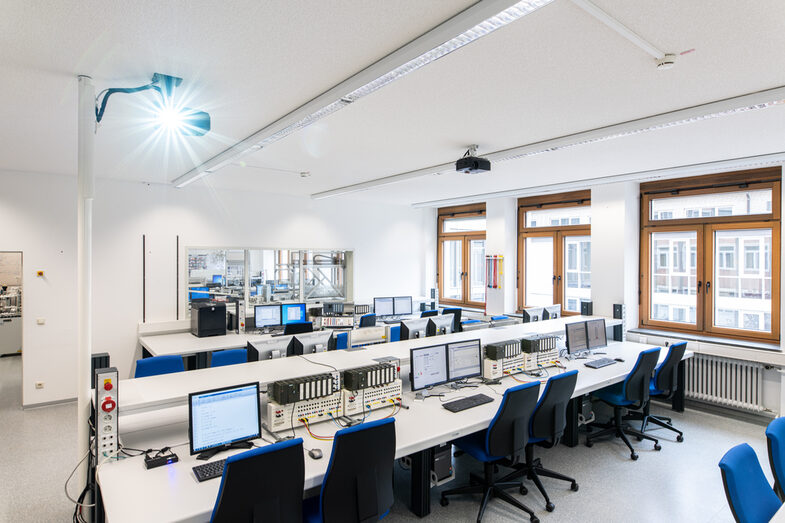 Room shot of the laboratory for control and regulation technology, process automation. Tables with PCs and various devices can be seen.