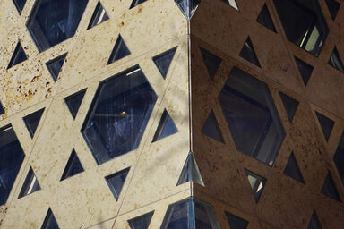 The outer wall of a synagogue with windows in the shape of the Star of David.